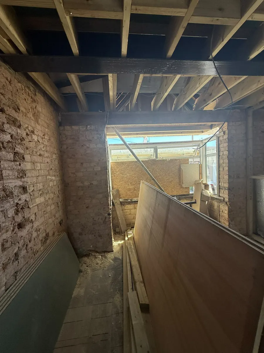 Loft space stripped back to brick, ready for reframing