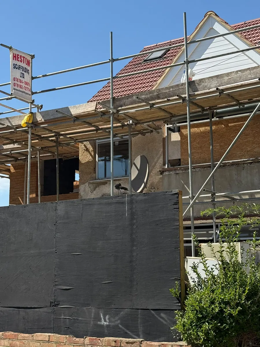 Rear extension under scaffold, with first fix roofing complete